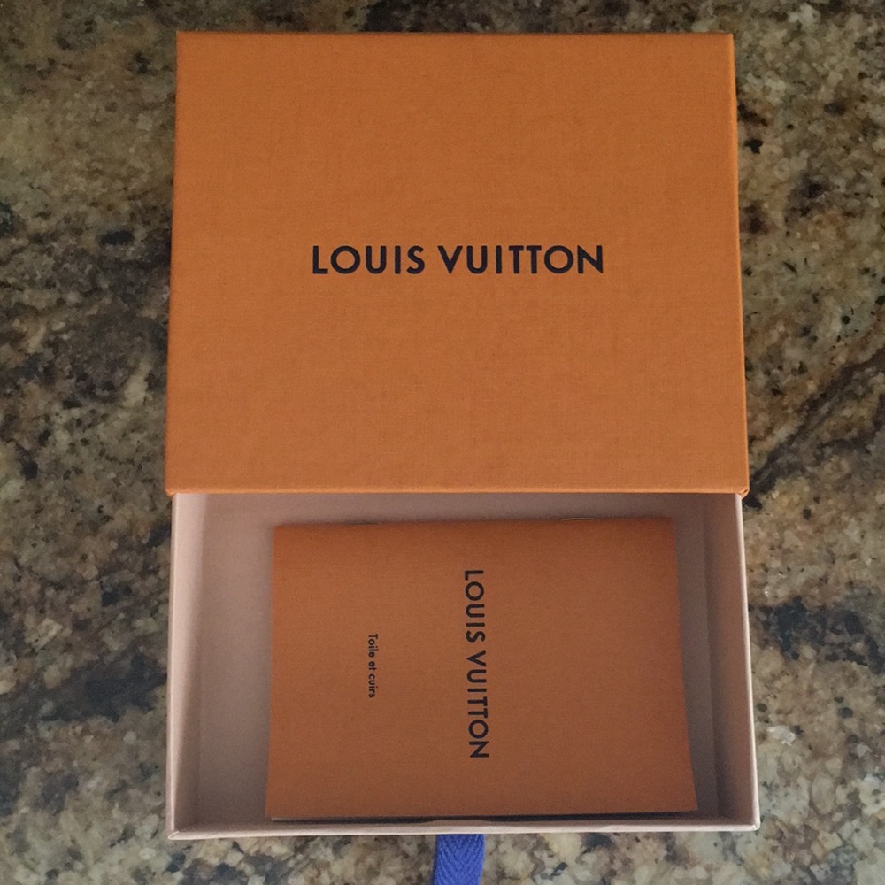 Empty Louis Vuitton box with little book.